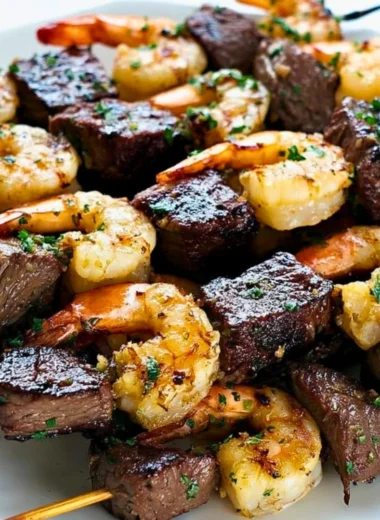 Delicious Surf and Turf Kebabs served with Chimichurri Sauce on a platter.