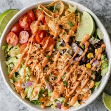 Colorful Taco Chicken Salad with grilled chicken, toppings, and dressing