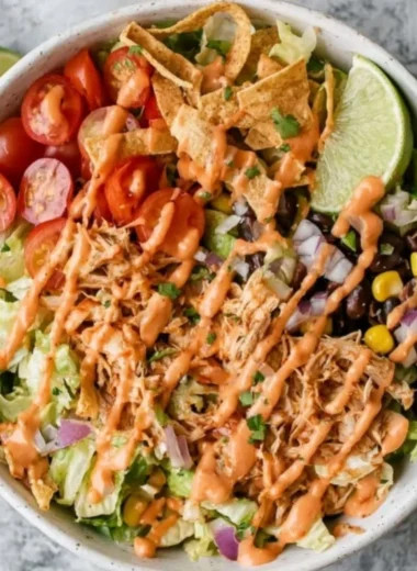 Colorful Taco Chicken Salad with grilled chicken, toppings, and dressing