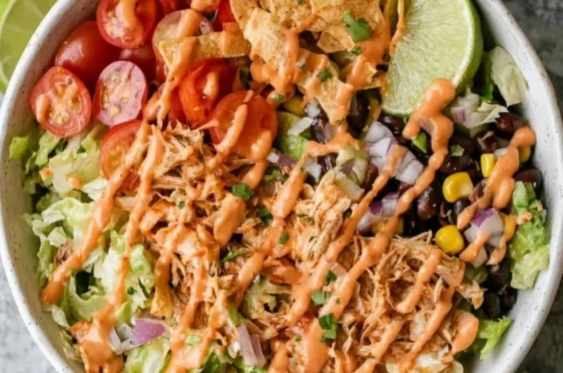 Colorful Taco Chicken Salad with grilled chicken, toppings, and dressing
