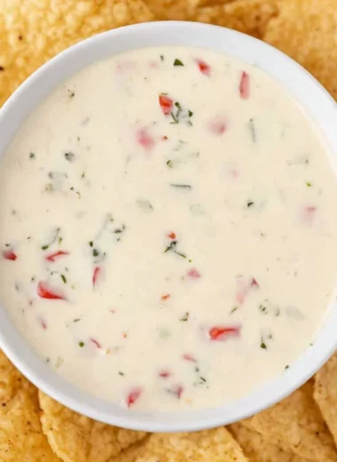 Bowl of creamy Mexican white cheese dip with tortilla chips