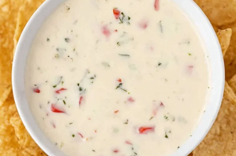 Bowl of creamy Mexican white cheese dip with tortilla chips