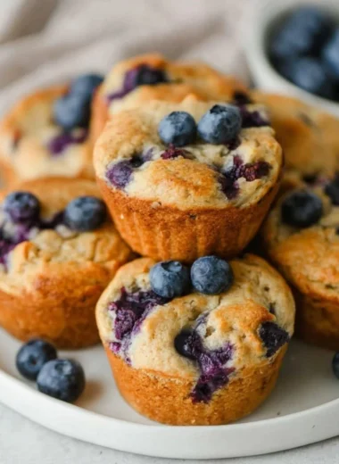 Freshly baked blueberry cottage cheese muffins on a rustic table