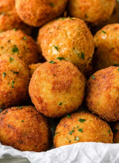 Delicious cheesy rice balls (arancini) served golden and crispy