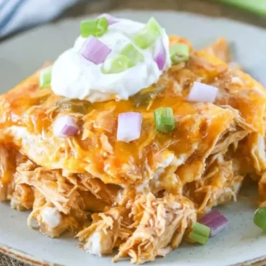 Delicious Chicken Enchilada Casserole topped with melty cheese and fresh ingredients