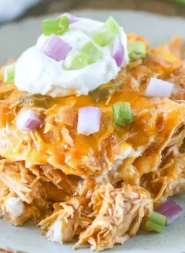 Delicious Chicken Enchilada Casserole topped with melty cheese and fresh ingredients