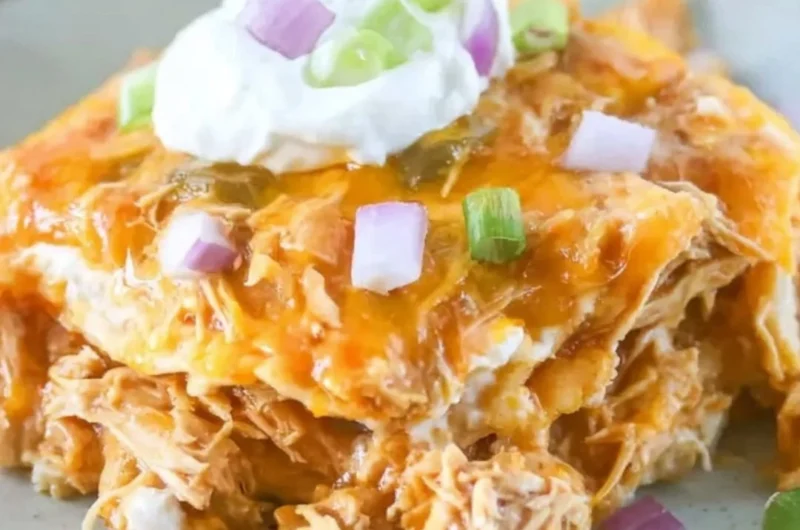 Delicious Chicken Enchilada Casserole topped with melty cheese and fresh ingredients
