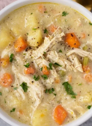 Bowl of Chicken Pot Pie Soup with vegetables and pie crust topping
