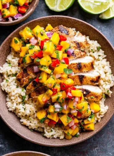 Chipotle lime grilled chicken served with vibrant mango salsa on a plate.