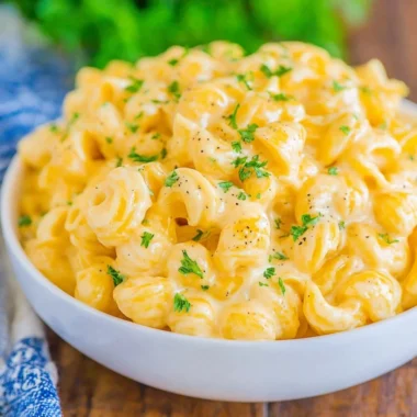 Bowl of creamy mac and cheese topped with breadcrumbs