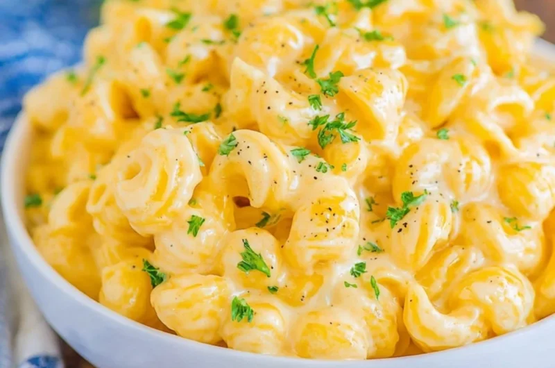 Bowl of creamy mac and cheese topped with breadcrumbs