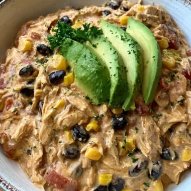 Delicious Crock Pot Fiesta Chicken served with colorful toppings.