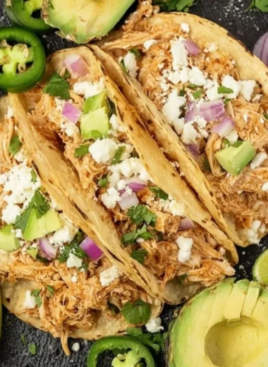 Crockpot Chicken Tacos served on a plate with fresh toppings
