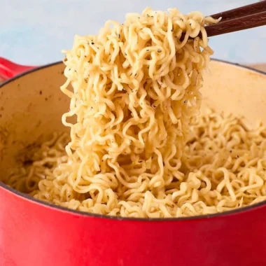 Delicious garlic butter ramen noodles topped with fresh herbs and spices.
