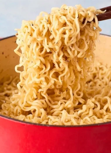 Delicious garlic butter ramen noodles topped with fresh herbs and spices.