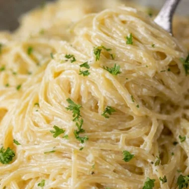 Creamy Garlic Parmesan Pasta with herbs and cheese in a bowl