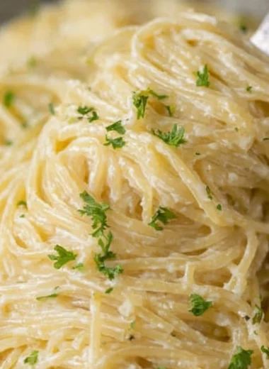 Creamy Garlic Parmesan Pasta with herbs and cheese in a bowl