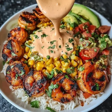 Grilled shrimp bowl with avocado, corn salsa, and creamy sauce.