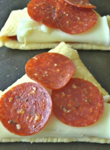 Delicious homemade Pizza Roll-Ups served in a plate with marinara sauce