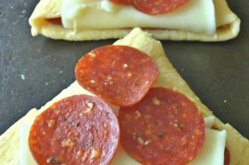 Delicious homemade Pizza Roll-Ups served in a plate with marinara sauce