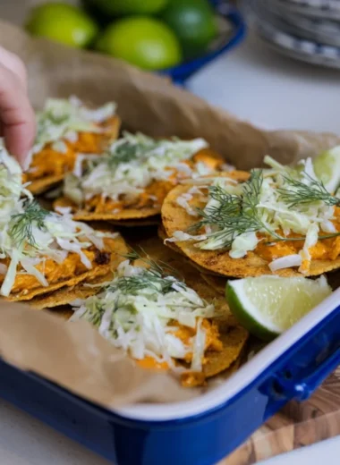 Smashed Buffalo Chicken Tacos with ranch slaw served on a plate