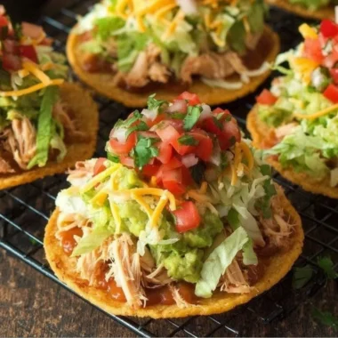 Delicious Chicken Tostadas topped with guacamole and beans