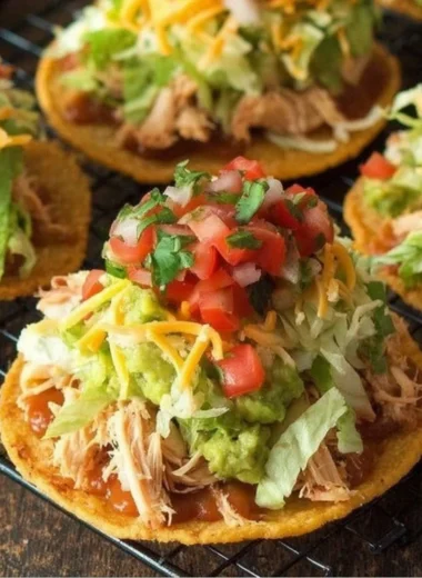 Delicious Chicken Tostadas topped with guacamole and beans